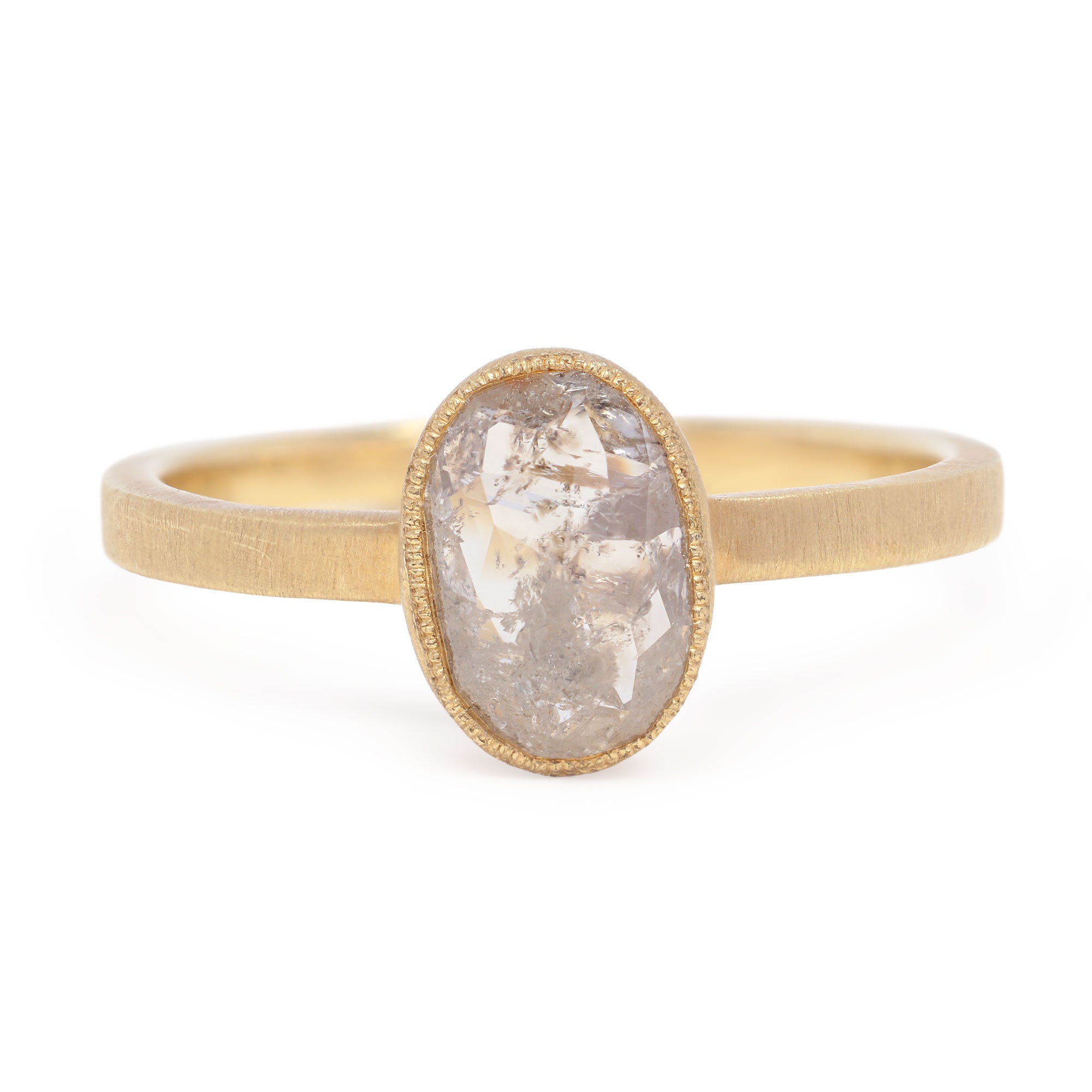 Gold ring with a large, oval-shaped stone on a white background