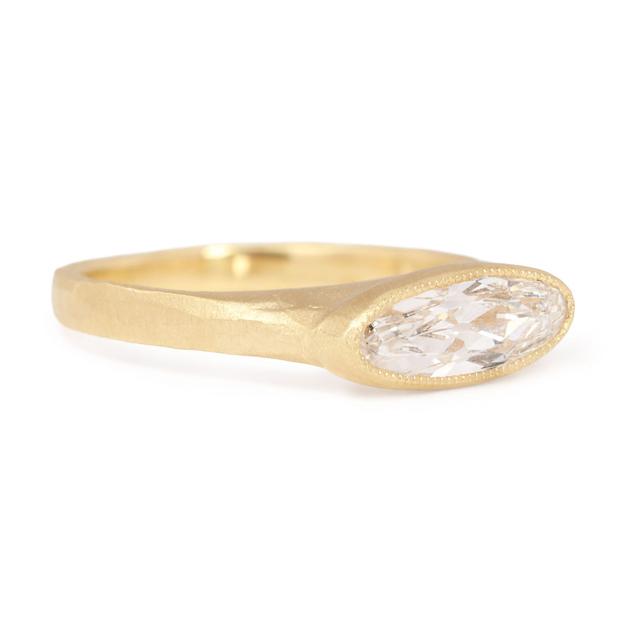 Gold ring with a diamond on a white background