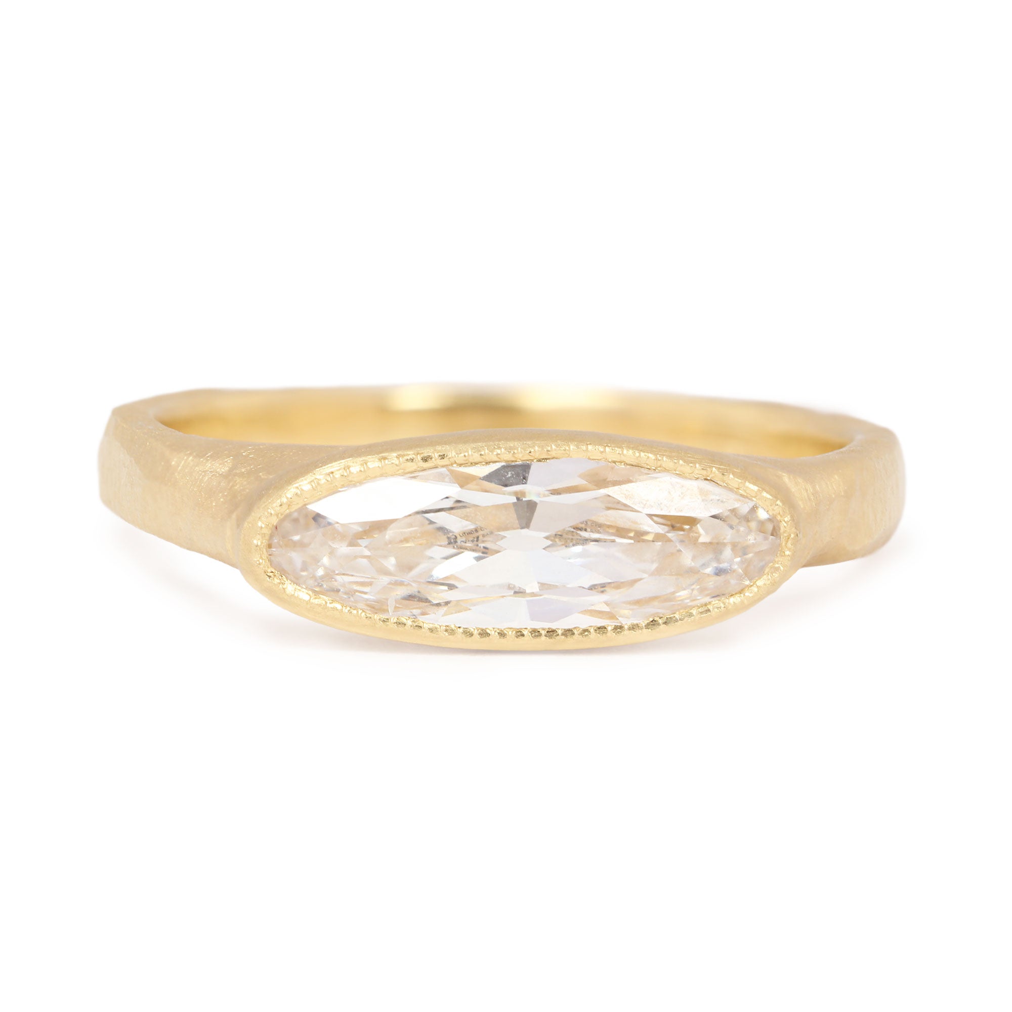 Gold ring with a diamond on a white background