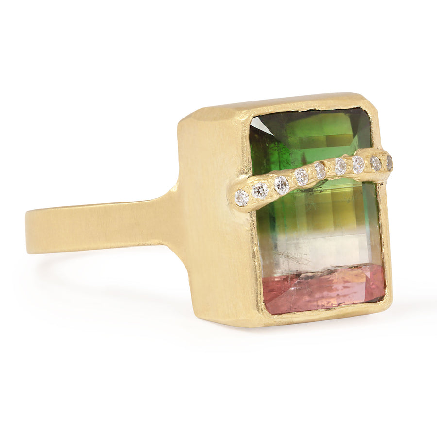 Gold ring with a multicolored gemstone on a white background