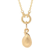 Gold necklace with a seed pod pendant on a white background