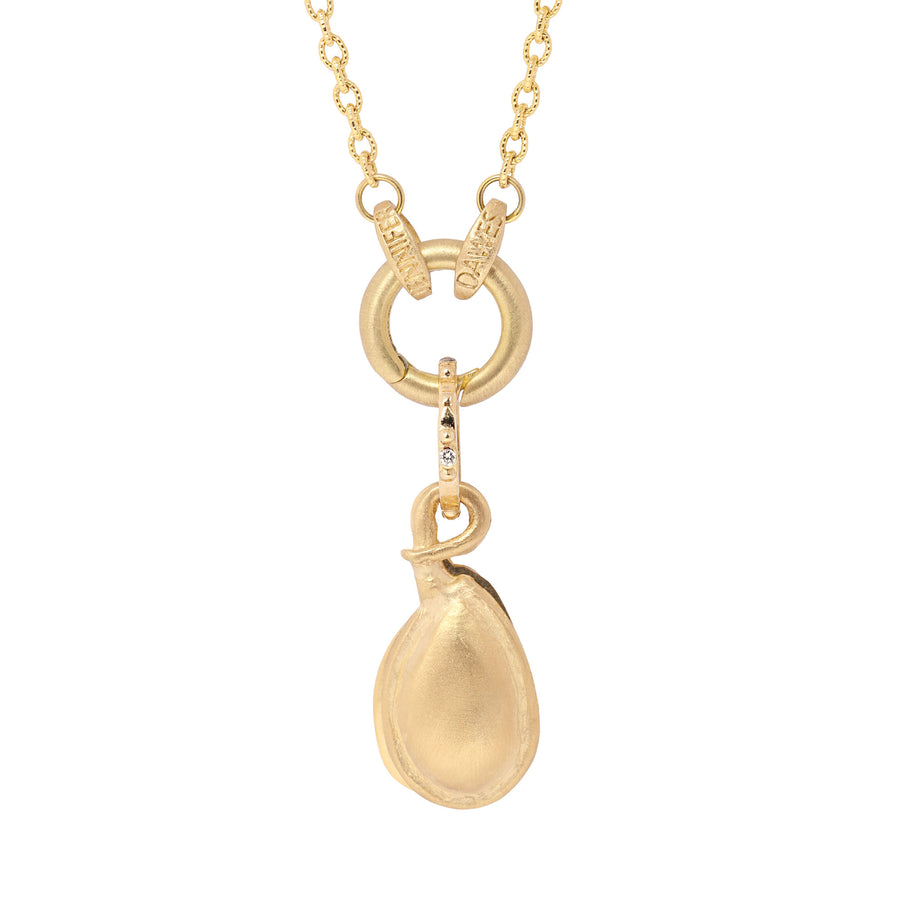 Gold necklace with a seed pod pendant on a white background
