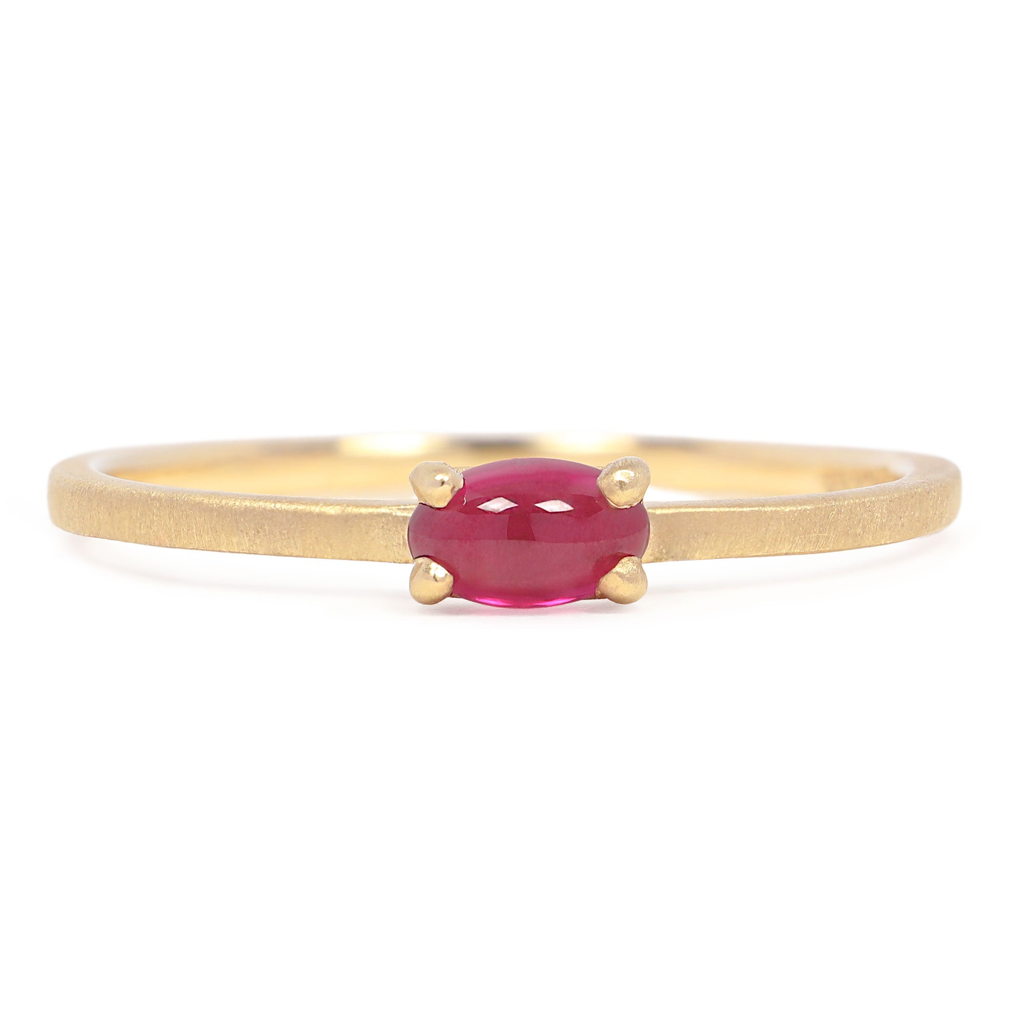 Gold ring with a pink gemstone on a white background