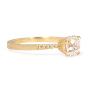 Gold ring with a diamond on a white background