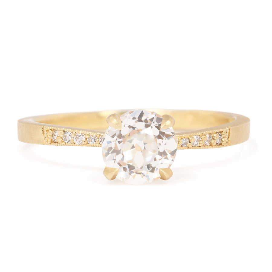 Gold ring with a diamond on a white background