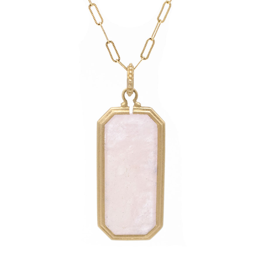 A 14k gold frame emerald cut morganite necklace with a beaded bail, suspending a pendulum-style chain.