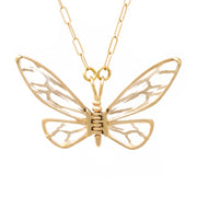 A gold-colored lace winged butterfly necklace with a textured chain.